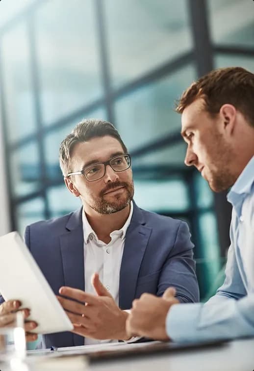 Two professionals discussing construction consulting details