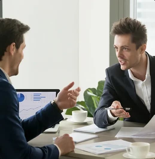 Two professionals discussing estimate pricing at a meeting Two professionals discussing estimate pricing at a meeting