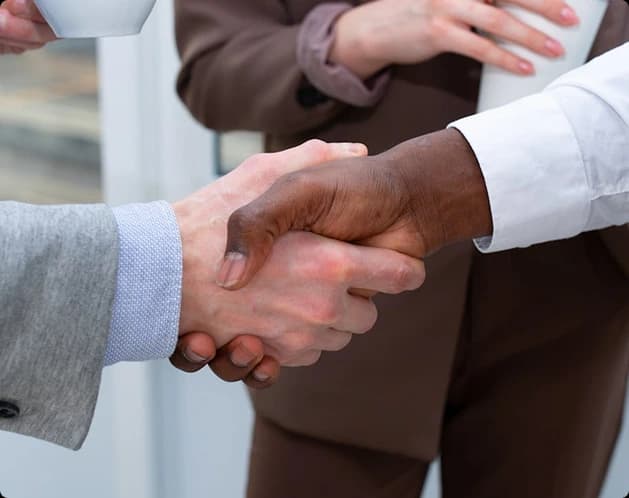 Handshake symbolizing trust between homeowner and contractor Handshake symbolizing trust between homeowner and contractor