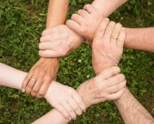Six hands, symbolizing unity and teamwork