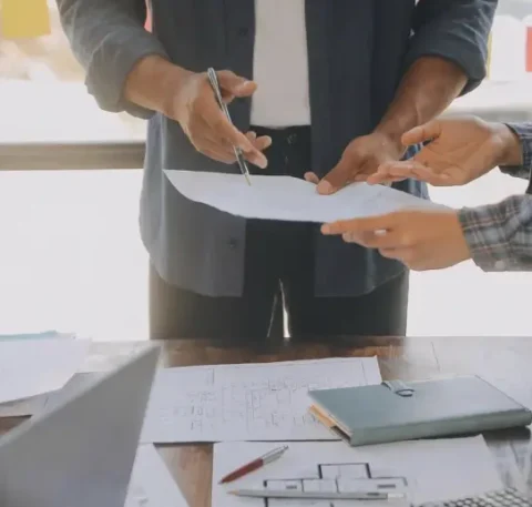 Two people are examining architectural plans.